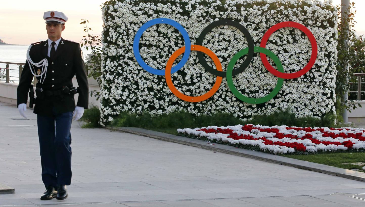 A Monaco's policeman walks past the Olympic rings during the opening of the 127th International Olympic Committee (IOC) session in Monaco on Dec 8, 2014. -- PHOTO: REUTERS