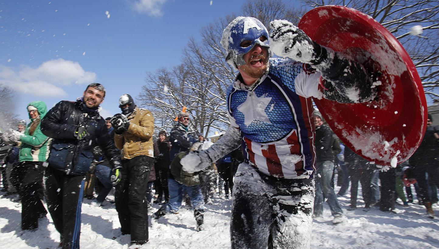 Mr Collin Lawrence, dressed up as comic superhero Captain America, joins other Washington DC residents in a massive snowball fight. -- PHOTO: REUTERS