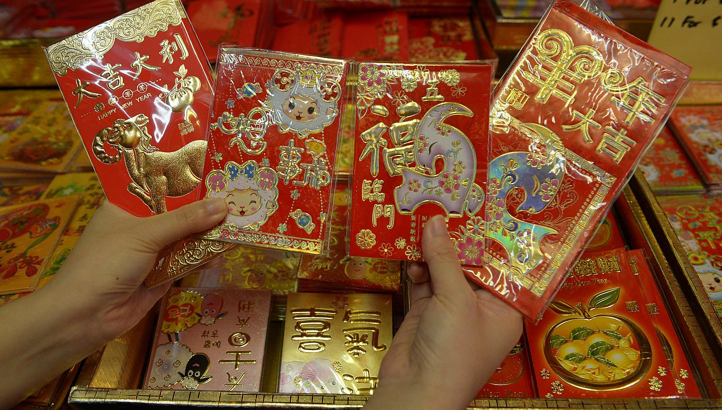 The Chinese tradition of giving gifts of money in red envelopes during the Lunar New Year has turned into big business for Web giants Alibaba and Tencent, which now both offer electronic hongbao. -- PHOTO: ST FILE