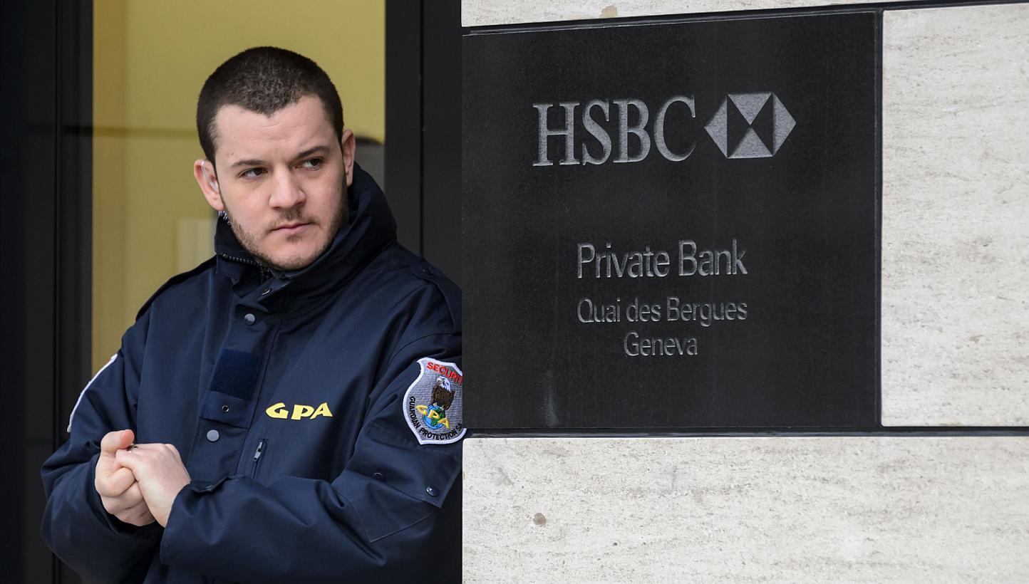 A private security guard secures the entrance of the HSBC Private Bank branch in Geneva on Feb 18, 2015. Ten days after a massive tax fraud scandal erupted surrounding British banking giant HSBC's Swiss branch, Swiss prosecutors announced a money lau