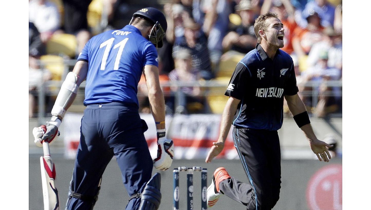 New Zealand's Tim Southee (right) celebrates dismissing England's Steven Finn (left) for a duck during their Cricket World Cup match at Wellington Stadium in Wellington on Feb 20, 2015. -- PHOTO: REUTERS