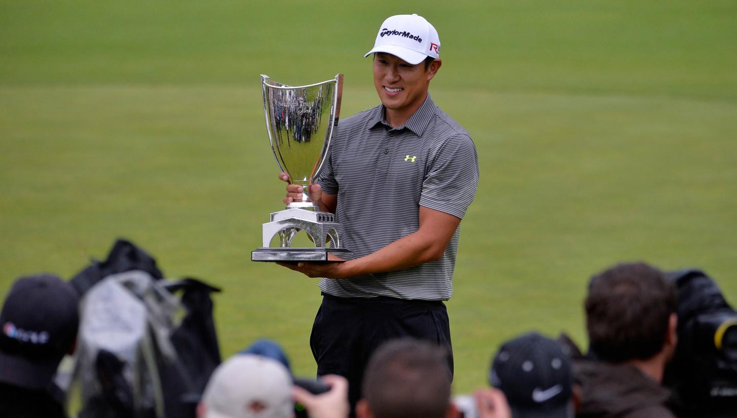 James Hahn holds the trophy on the 18th hole after putting in for the win on the 14th hole amid the Final Round of the Northern Trust Open at the Riviera Country Club on Feb 22, 2015 in Pacific Palisades, California. -- PHOTO: AFP