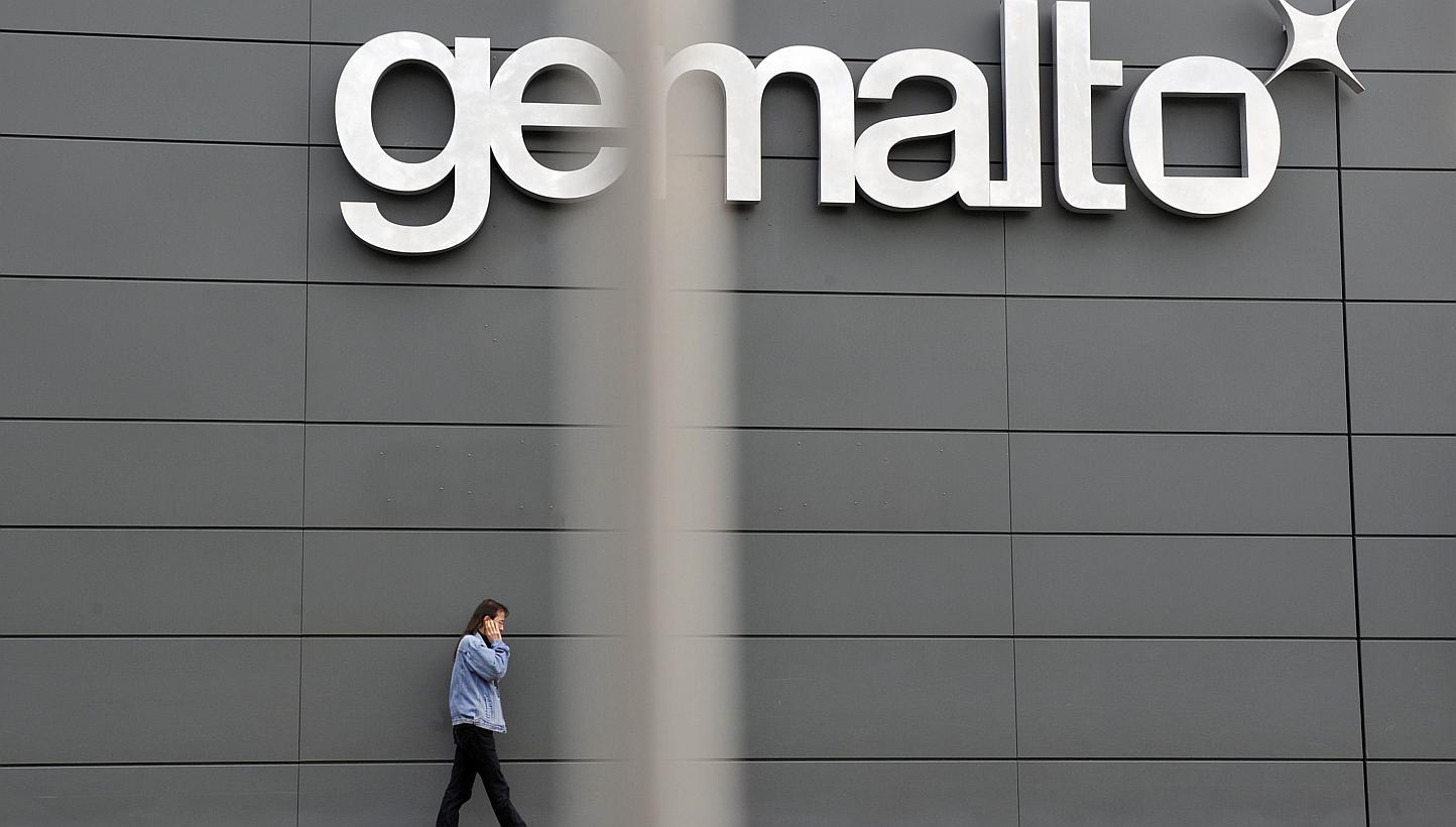 A file picture taken on November 10, 2009 shows an employee walking outside the Gemalto building, the world's leading digital security firm, in Gemenos, southern France.&nbsp;Gemalto NV, the maker of mobile-phone card software, said Wednesday it dete