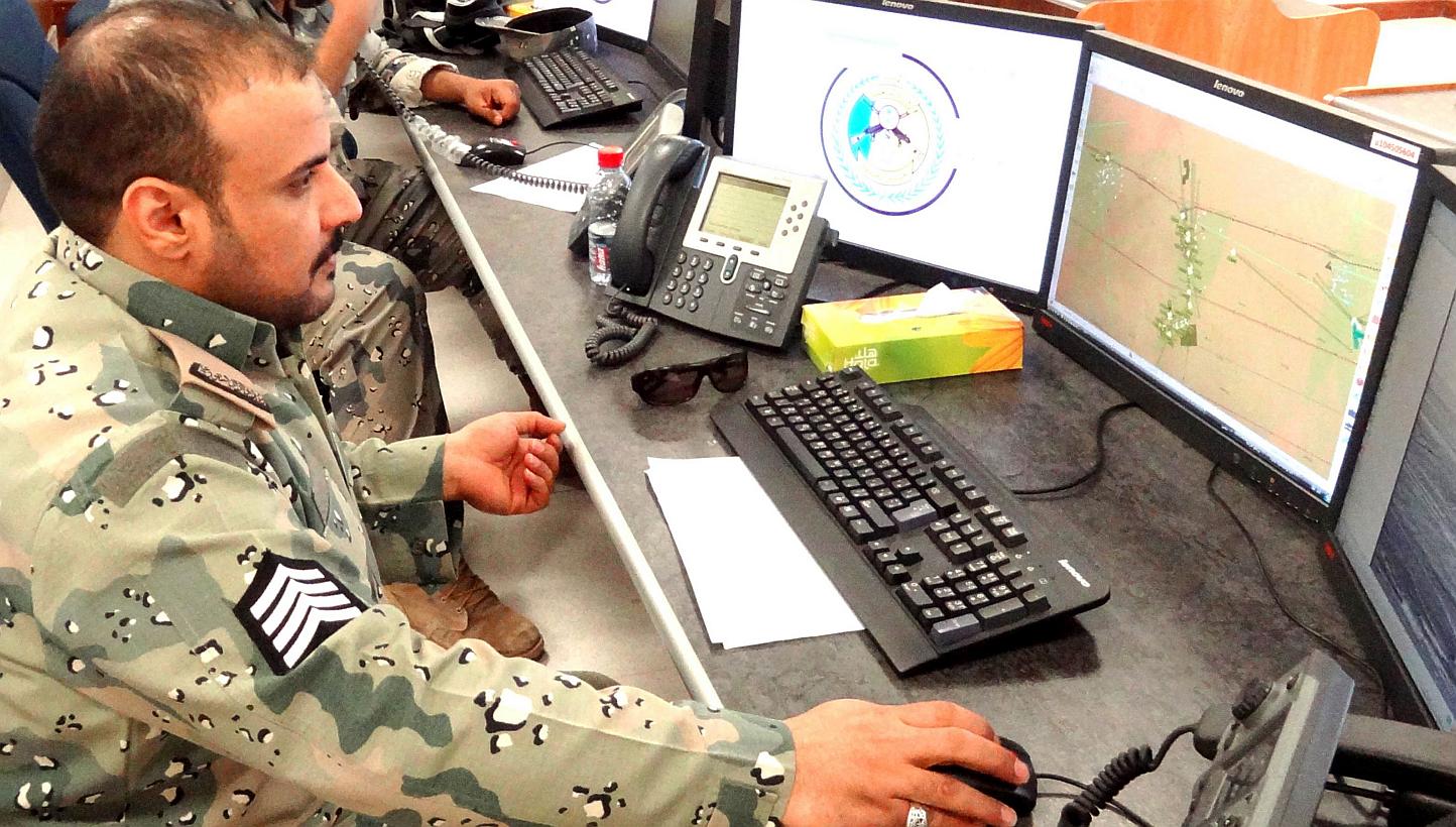 Saudi border guards monitor cameras and radars on surveillance screens of the Saudi northern border with Iraq at Arar regional command and control centre headquarters in Arar city. Inaugurated last September, the double-fence system and its complemen