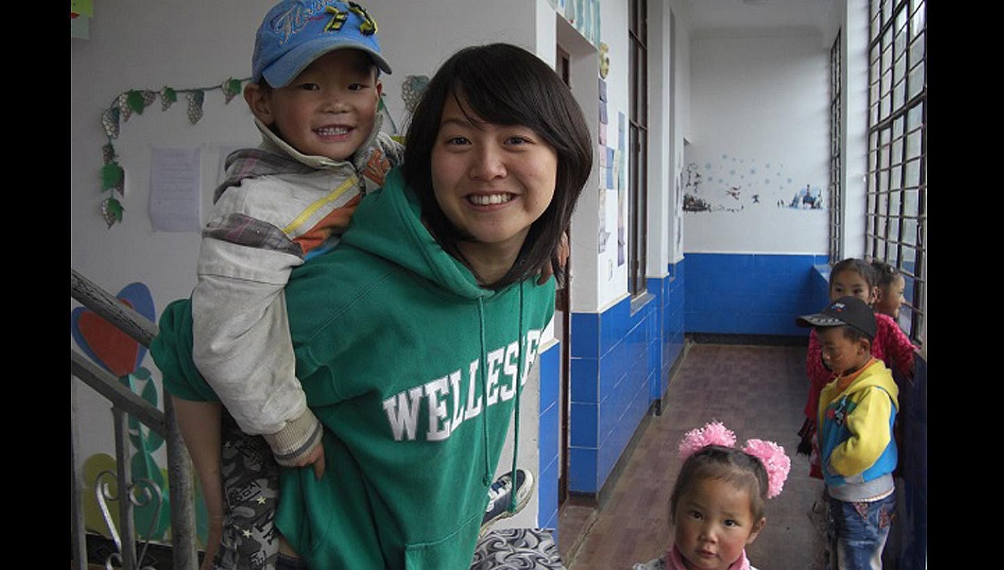 Miss Davina Huang with children at a kindergarten in Yunnan, China, during a teaching stint in 2011. The school will be one of the beneficiaries of funds originally raised to help her family with the medical costs.