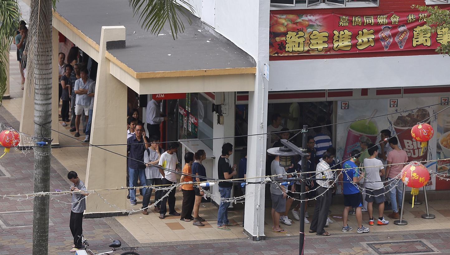 The queue for this year's $12-million jackpot has already started, with snaking queues at hotspot 7-Eleven outlet of Block 102 Yishun Avenue 5 on Thursday. -- PHOTO: ST FILE