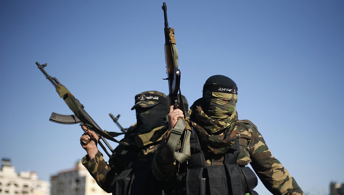 Palestinian militants leave after representatives of various Palestinian armed factions held a news conference to condemn the decision of an Egyptian court that banned Hamas' armed wing, in Gaza City, Feb 5, 2015. -- PHOTO: REUTERS