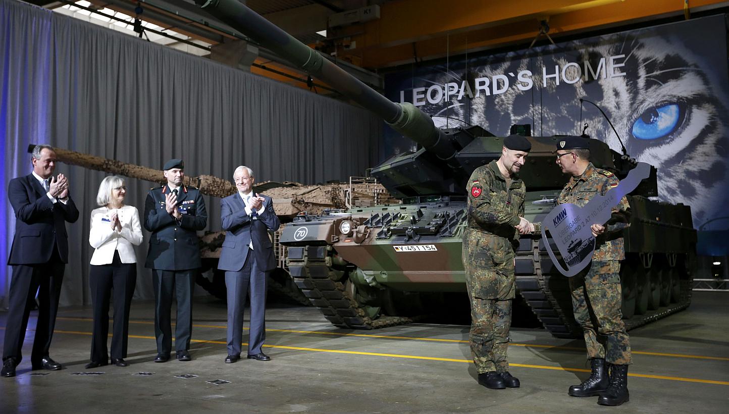 German General Rainer Korff (right) hands over a symbolic key to Master Sergeant Sascha Sieson during the handover of the new tank Leopard 2A7 from Krauss-Maffei Wegmann (KMW) to the German armed forces in Munich on Dec 10, 2014.&nbsp;Germany will sp