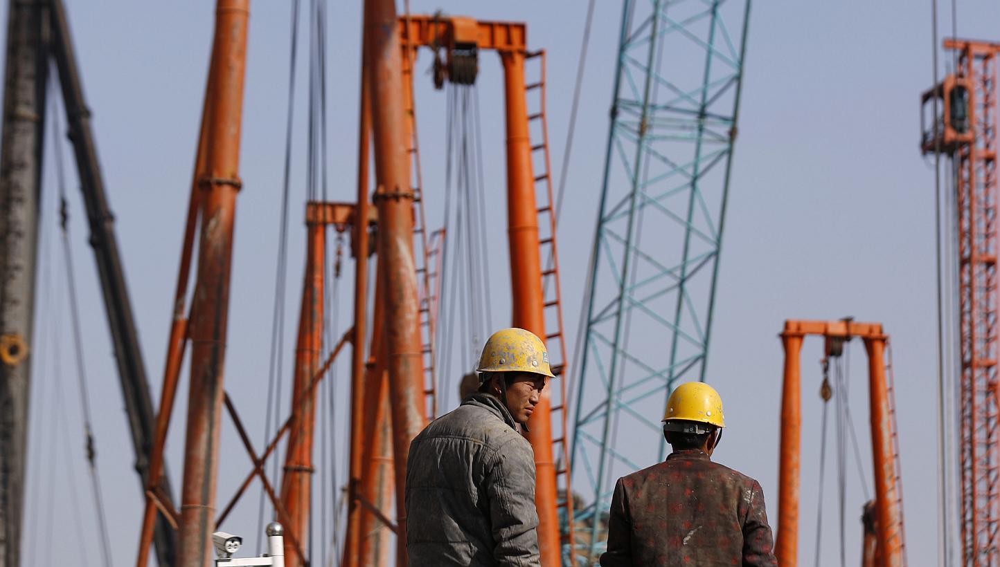 Labourers work at a construction site in Shanghai. Activity in China's factory sector contracted for a second straight month in February, according to an official survey released on Sunday, only hours after the Chinese central bank cut interest rates