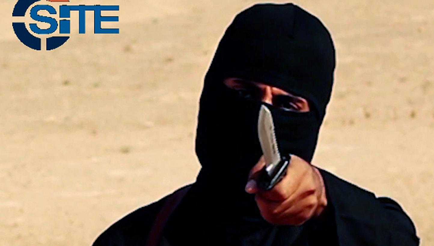 A masked, black-clad militant, who has been identified by the Washington Post newspaper as a Briton named Mohammed Emwazi, brandishes a knife in this still image from a 2014 video obtained from SITE Intel Group on Feb 26, 2015. -- PHOTO: REUTERS