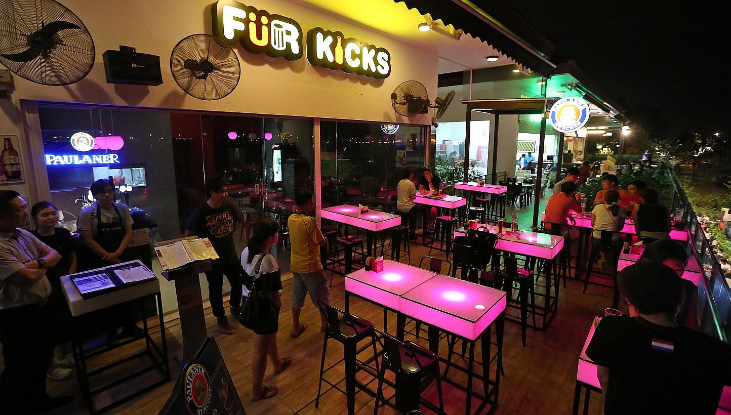 Punggol newcomers also include bistro bar Fur Kicks (left) in The Punggol Settlement. Brunch cafe Whisk & Paddle in Tebing Lane is co-owned by (above from left) Pan siblings Victoria, 29, Junjie, 26, and Shushan, 28. With them is chef Mario Ian Lee (