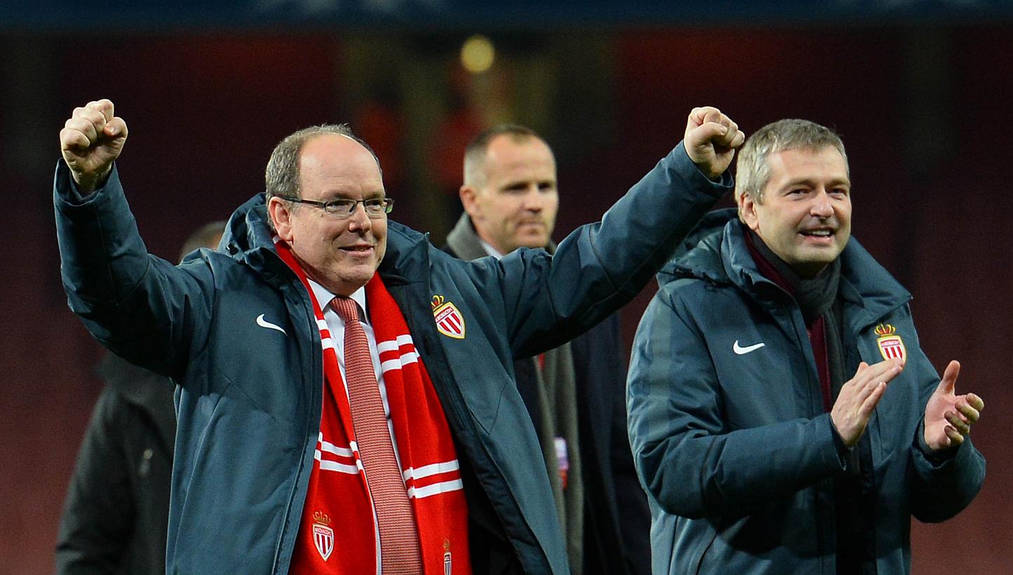 Prince Albert II of Monaco (left) celebrates on the field with Monaco's Russian president Dmitry Rybolovlev (right) after the final whistle of the UEFA Champions League round of 16 first leg football match between Arsenal and Monaco at the Emirates S