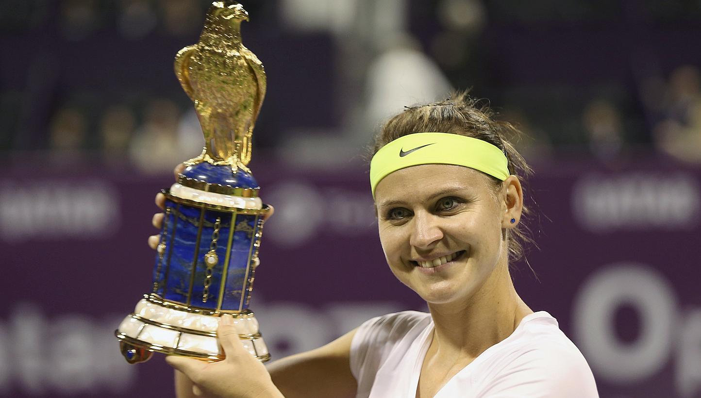 Lucie Safarova of the Czech Republic holds up her trophy after defeating Belarus' Victoria Azarenka in their women's singles final match at the Qatar Open tennis tournament in Doha on Feb 28, 2015. -- PHOTO: REUTERS
