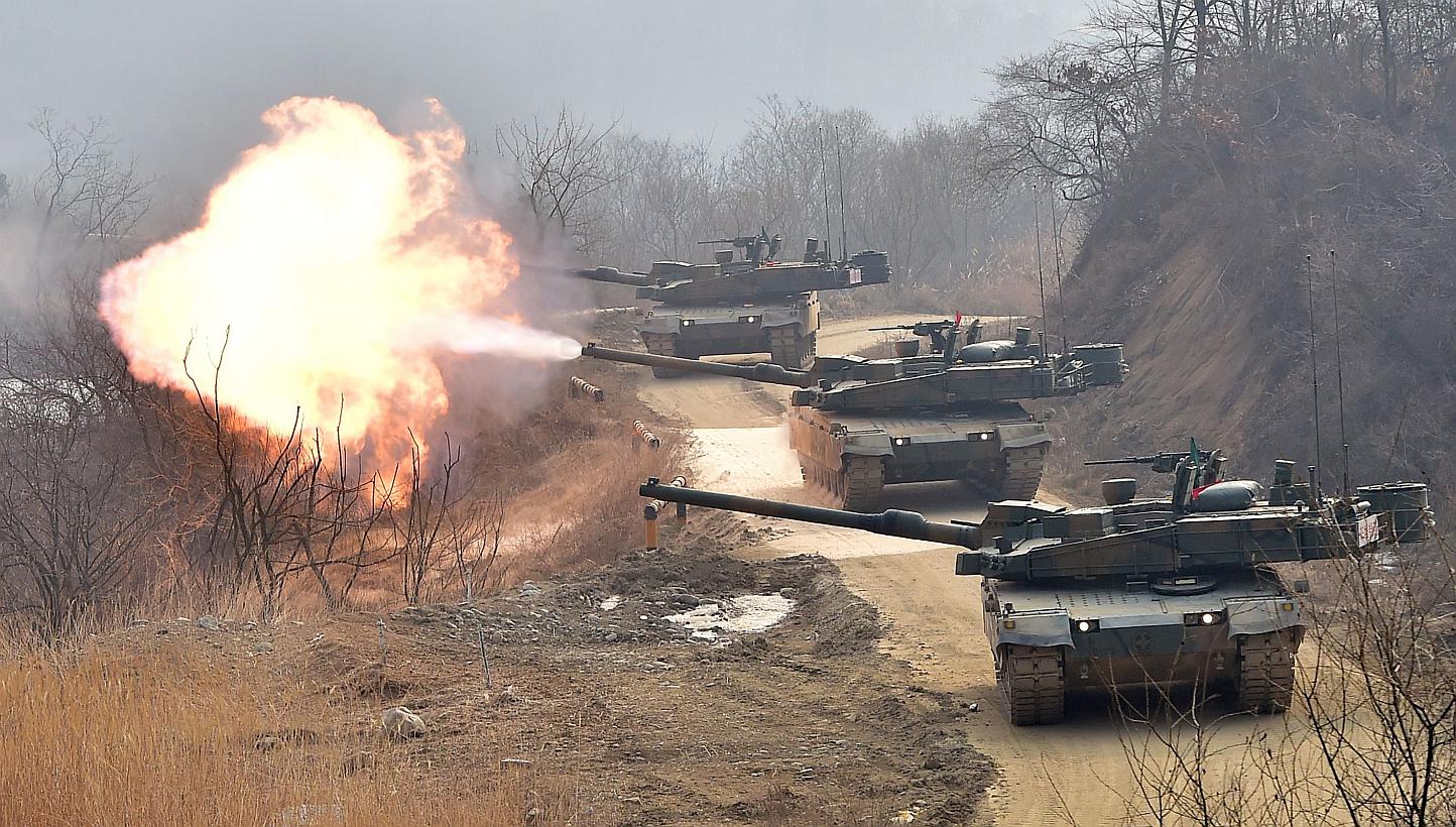 South Korean army's K-2 tanks fire during a live-fire drill in Yangpyeong, 60 km east of Seoul, on Feb 11, 2015.&nbsp;North Korea on Monday fired missiles into the sea and vowed to carry out "merciless strikes" against the United States and South Kor