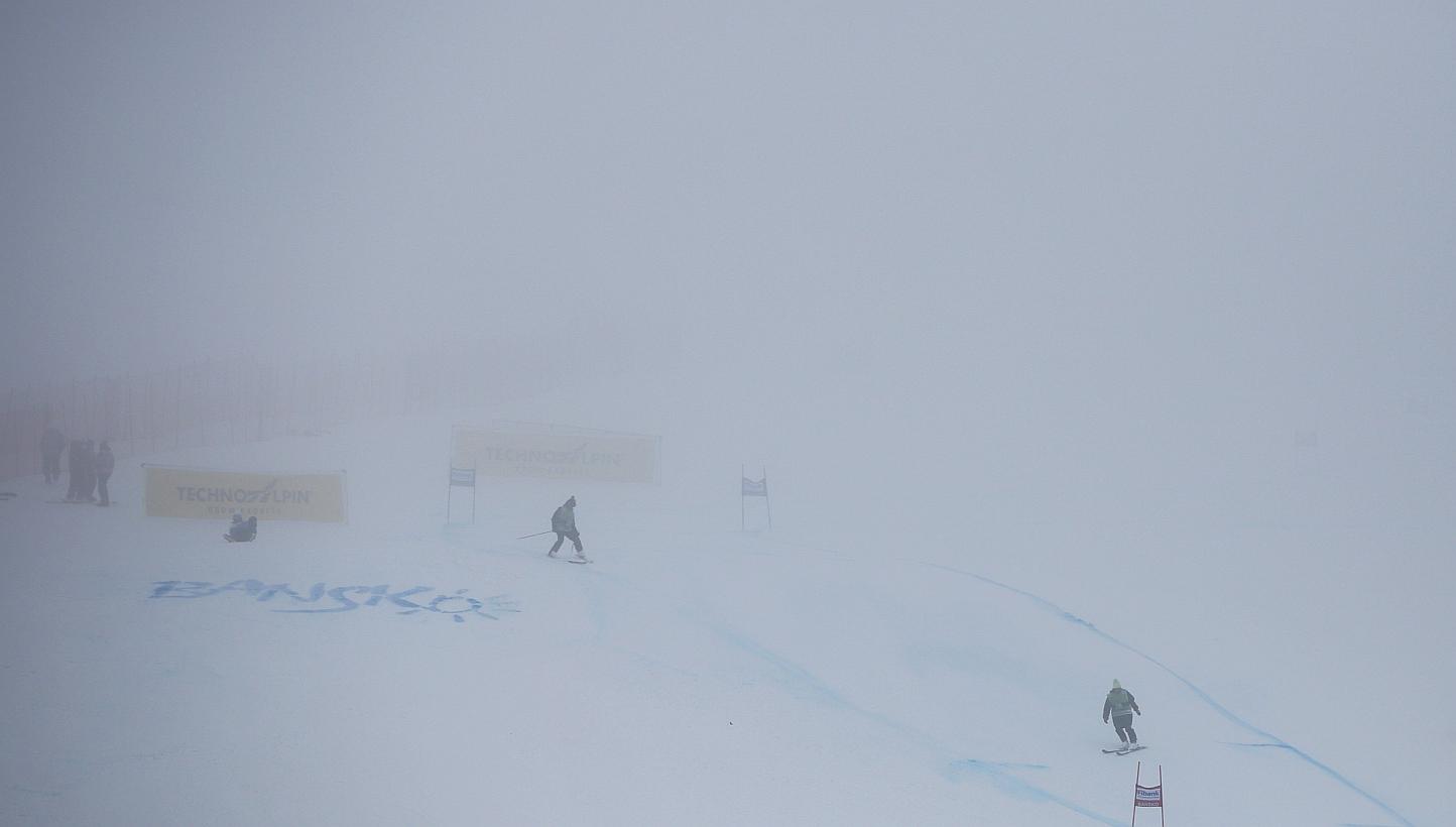 Staff works on the slope before the Women's Alpine Skiing World Cup Super G race in Bansko, Bulgaria on Feb 26. Unstable fog weather conditions forced the cancellation of the women's Super G World Cup ski race, organisers said. -- PHOTO: EPA