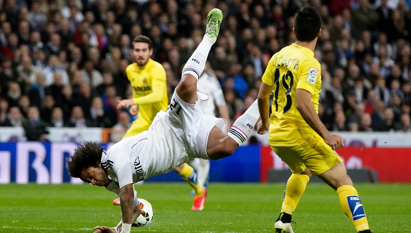 Real Madrid's Brazilian defender Marcelo (left) vies with Villarreal's defender Jaume Costa during the Spanish league football match Real Madrid CF vs Villarreal CF at the Santiago Bernabeu stadium in Madrid on Sunday. -- PHOTO: AFP&nbsp;