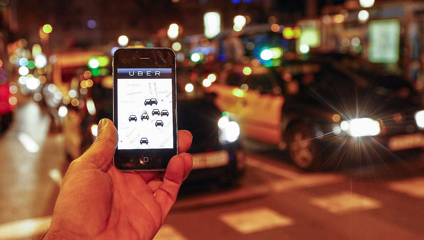 Uber helps you book a taxi or private car to take to your desired destination for a fee. -- PHOTO: AFP&nbsp;