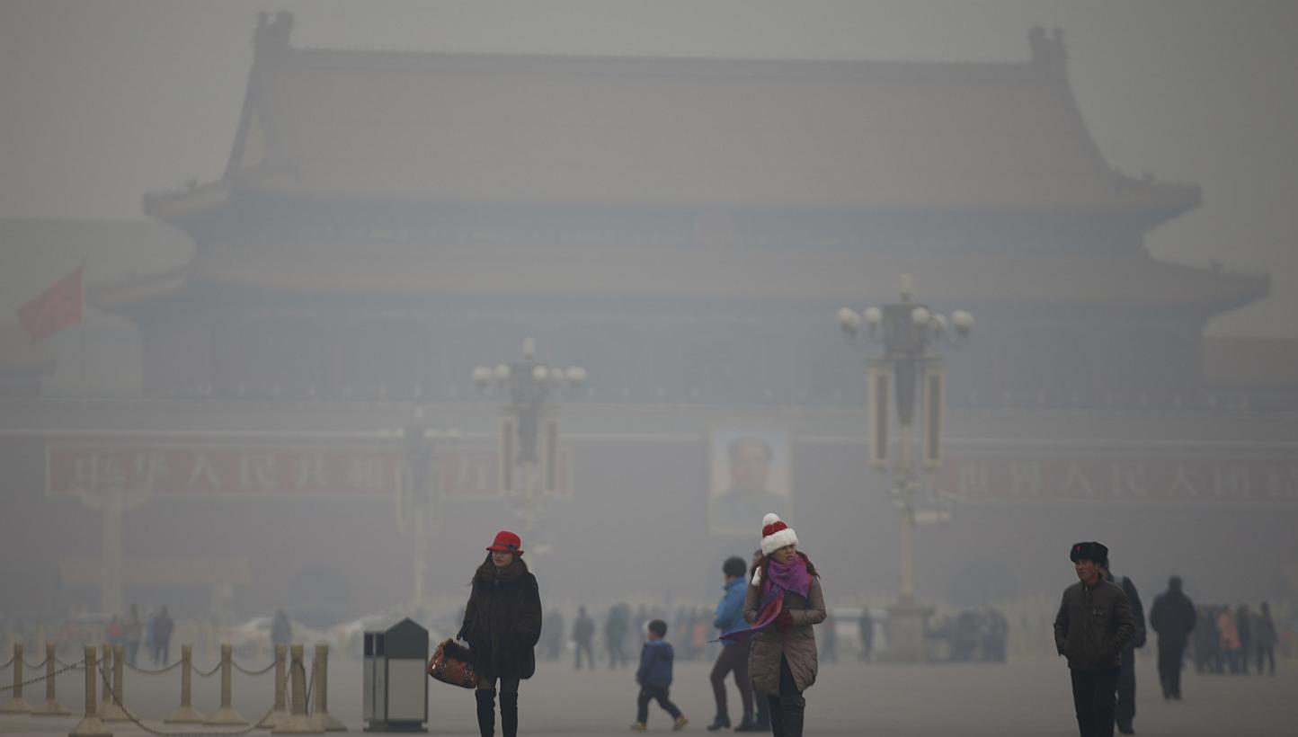 Visitors take a walk during a polluted day at Tiananmen Square in Beijing on Jan 15, 2015. One year after "declaring war" on pollution, China has appointed an inexperienced outsider - environmental scientist, Mr Chen Jining - as its new Minister of E