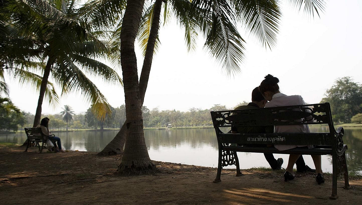 Couples at a park in Bangkok on Feb 11, 2015. -- PHOTO: REUTERS