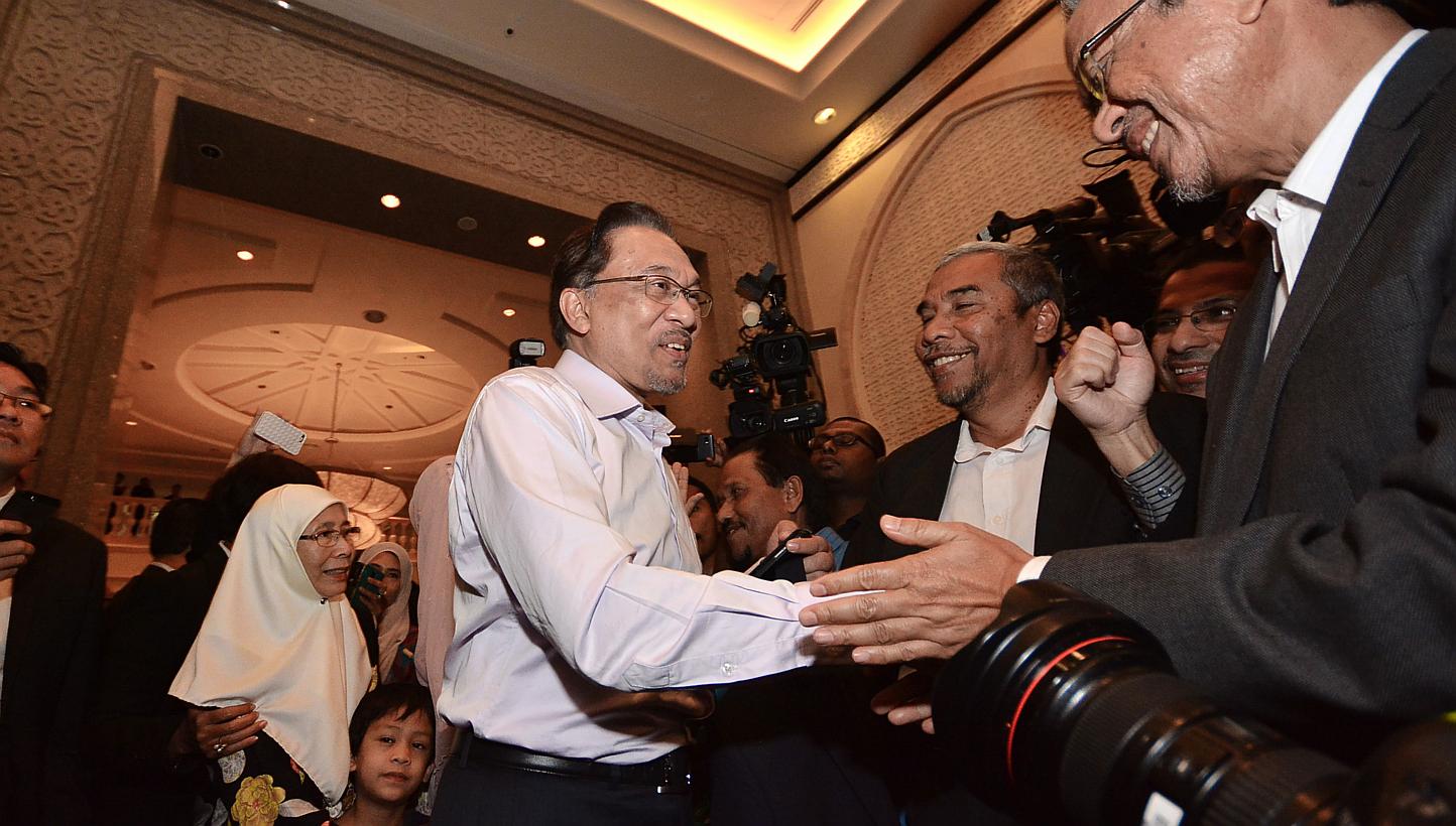 Malaysian opposition leader Anwar Ibrahim (centre) and his wife Wan Azizah (back left) arrive at the Federal Court ahead of a ruling on his appeal of a sodomy conviction in Putrajaya, outside Kuala Lumpur on Feb 10, 2015. An appeal for Anwar to atten
