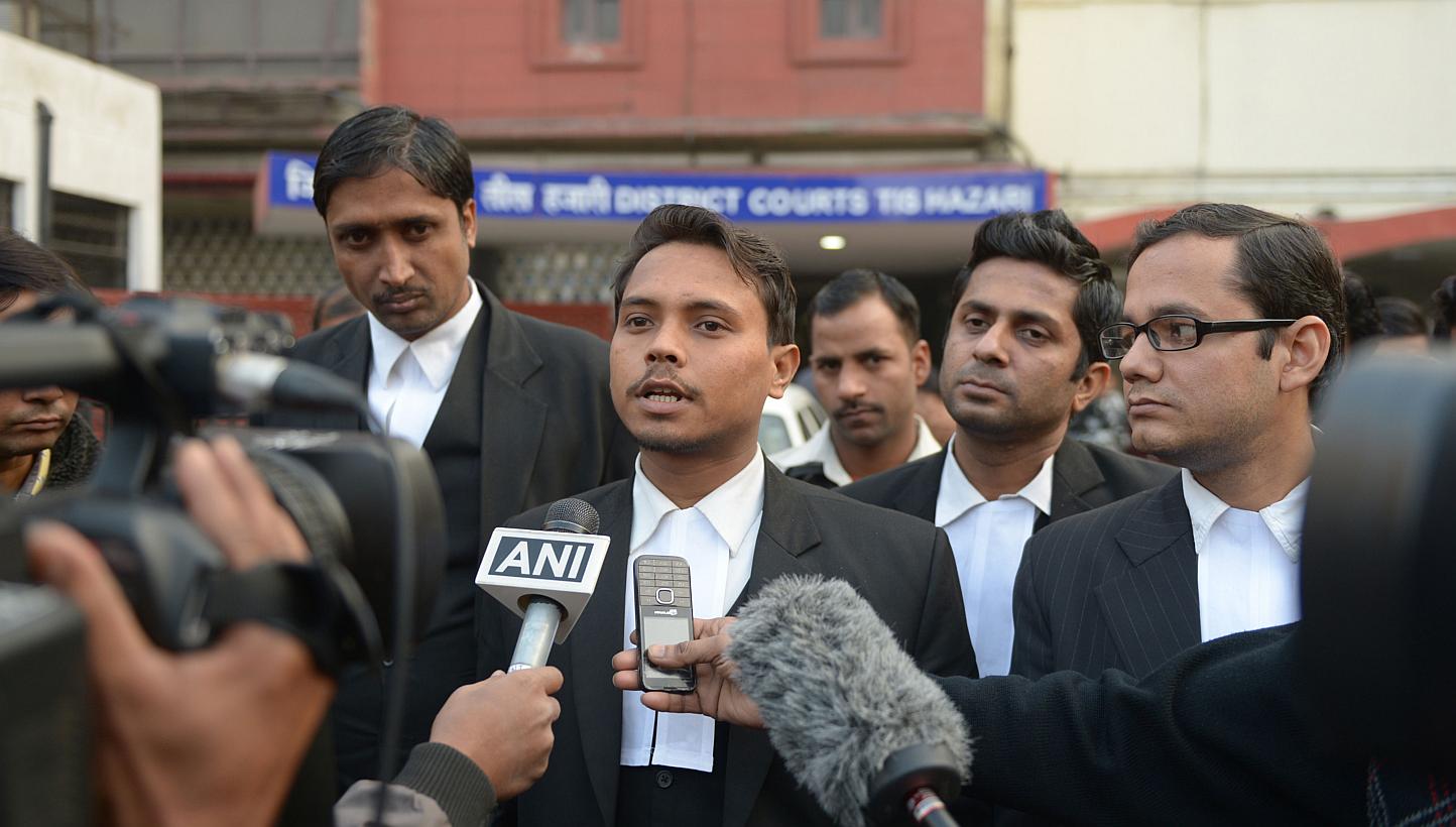 Indian lawyer Alok Dwivedi (centre), who represents Uber taxi driver Shiv Kumar Yadav, who has been accused of the rape of a female passenger, speaks to media outside the Tis Hazari District court in New Delhi on Jan 15, 2015.&nbsp;An Indian court on