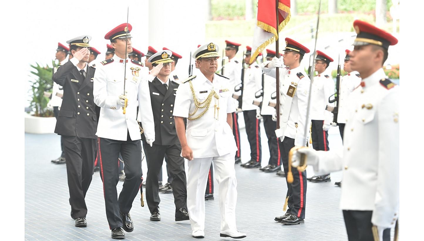 First Admiral (Fadm) Dato Seri Pahlawan Abdul Aziz Haji Mohammad Tamit inspecting a guard of honour at the Ministry of Defence. -- PHOTO: MINDEF&nbsp;