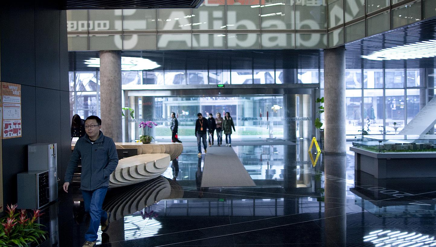People walk through Alibaba's headquarters in Hangzhou, Zhejiang Province, China. The Internet company is launching a cloud computing hub in Silicon Valley on Wednesday, the e-commerce giant's first outside of China, underscoring its global ambitions