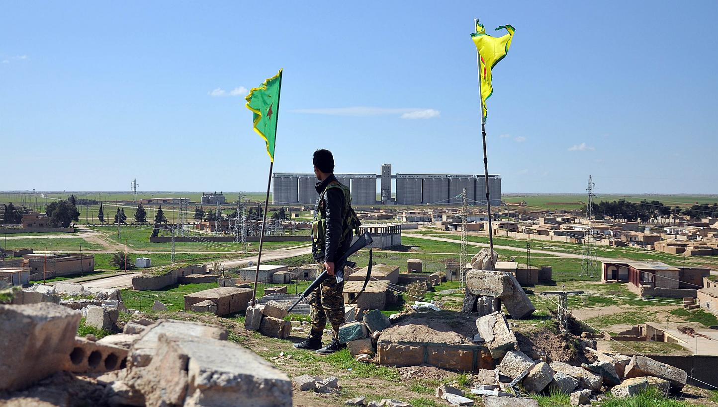 A Kurdish People's Protection Units fighter standing on top of a hill overlooking the the town of Tal Hamis, south-east of the city of Qamishli, on March 1, 2015. A former Royal Marine has become the first British fighter to be killed battling alongs