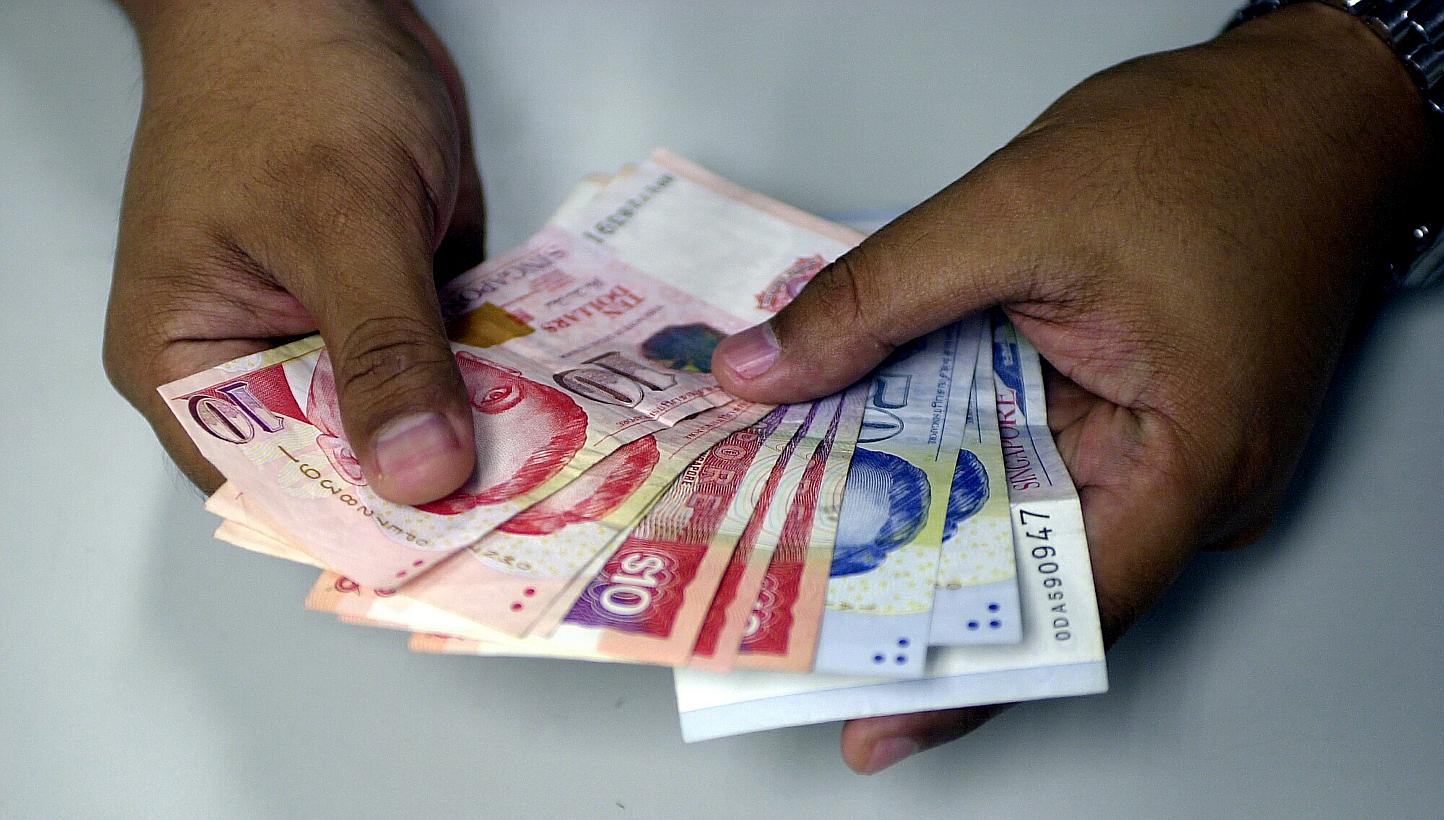 The Singdollar's low ebb comes amid market talk that the central bank here will next month move to allow the local currency to soften further to give a lift to manufacturers, as the inflation threat recedes. -- PHOTO: ST FILE