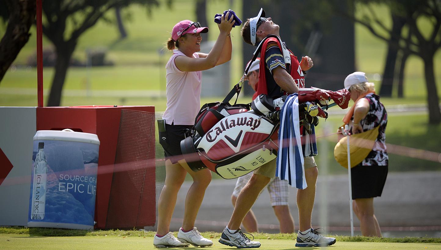 Lydia Ko of New Zealand jokes with her caddie after teeing off at the 11th hole during the Pro-am event on the eve of the HSBC Women's Champions on March 4, 2015. -- ST PHOTO: MARK CHEONG