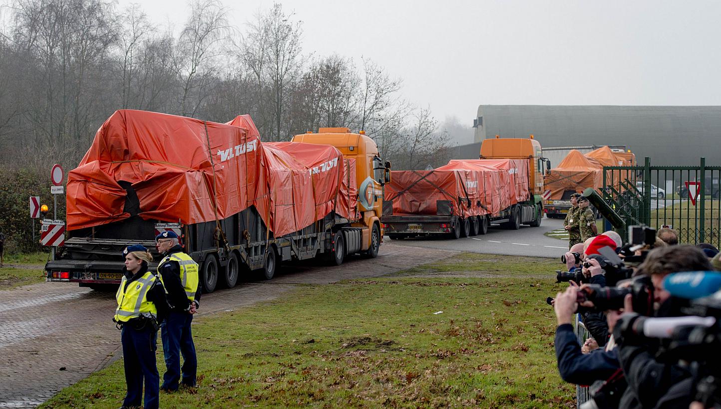 Lorries carrying the wreckage of the passenger airplane MH17 that crashed in Ukraine arrive at Gilze-Rijen airbase in the Netherlands on Dec 9 last year. -- PHOTO: AFP