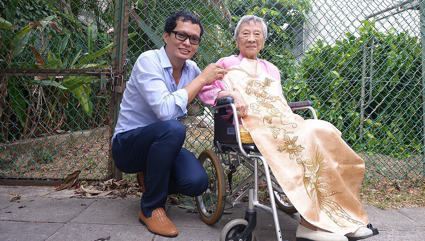 Artist-architect Randy Chan with Madam Maggie Kwek and her cheongsam dating back to the 1940s. -- ST PHOTO: DANIEL NEO