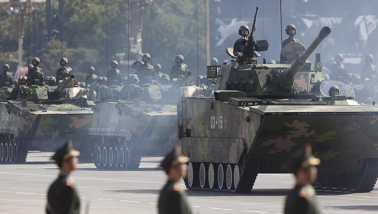 Chinese People's Liberation Army tanks move down Changan Ave. during a military parade in Beijing, China. Amid a slowing economy, China has raised its defence budget by 10.1 per cent to 887 billion yuan (S$193.4 billion) this year, keeping its nearly