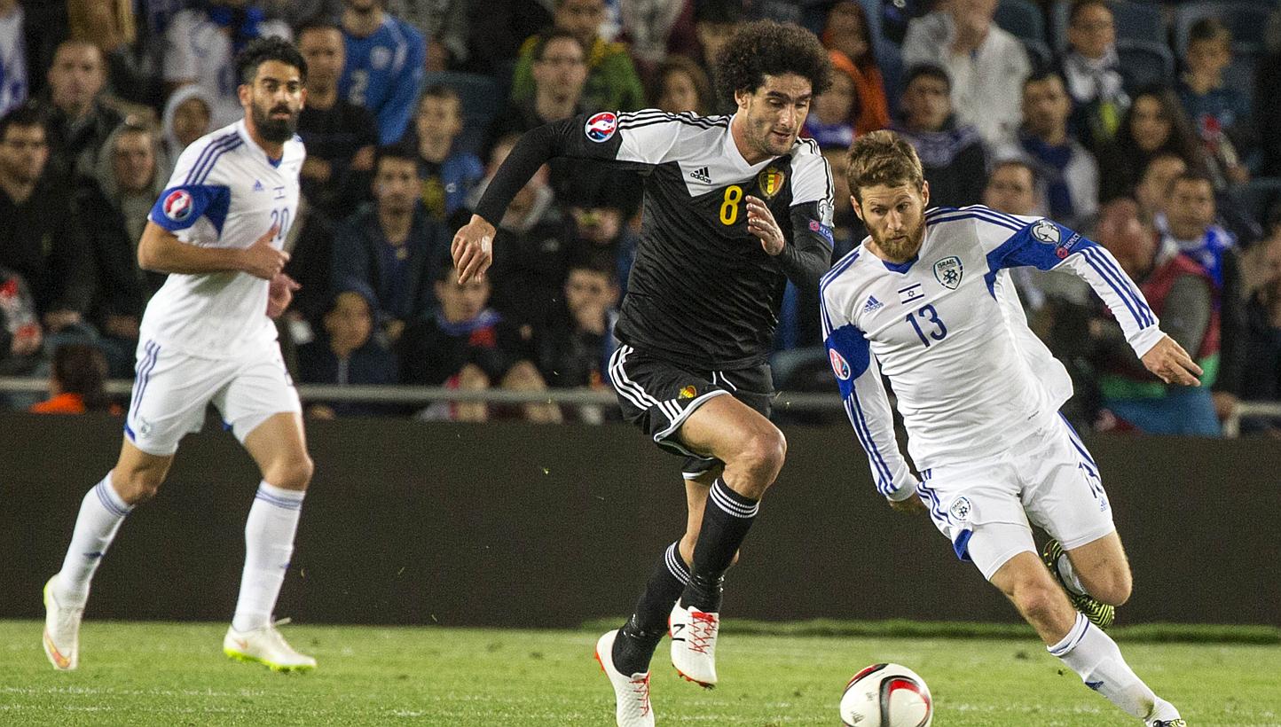 Israel's midfielder Sheran Yeini (right) vying with Belgium's midfielder Marouane Fellaini during their Euro 2016 qualifying football match match between Israel and Belgium on March 31, 2015. -- PHOTO: AFP