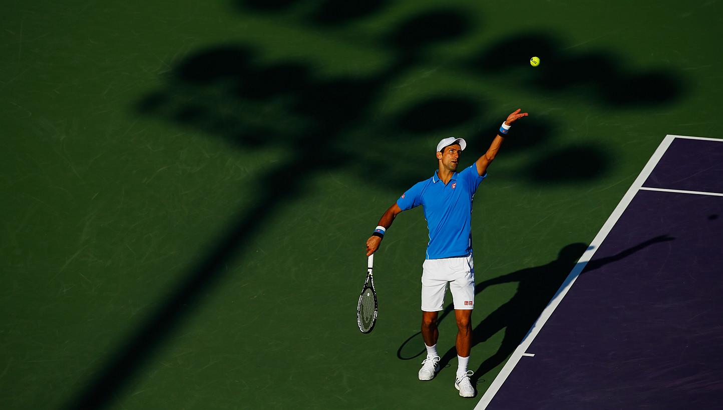 Novak Djokovic serving against Alexandr Dolgopolov during day 9 of the Miami Open at Crandon Park Tennis Center on March 31, 2015, in Key Biscayne, Florida. -- PHOTO: AFP