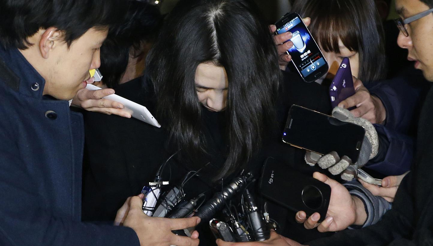 Cho Hyun Ah (centre), also known as Heather Cho, daughter of chairman of Korean Air Lines Cho Yang Ho, is surrounded by the media as she leaves the Seoul Western District Prosecutor's office on Dec 30, 2014. The Seoul High Court began hearing an