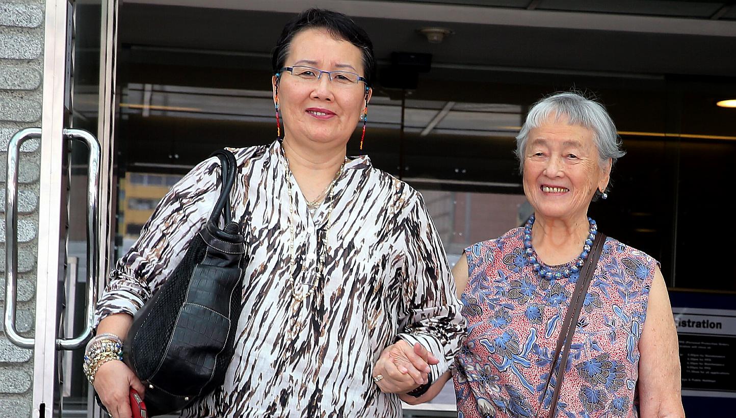 Madam Chung Khin Chun (left) and her niece Hedy Mok (far left) at the Family Justice Courts yesterday. Madam Chung made a new will last December which leaves most of her assets to charity.