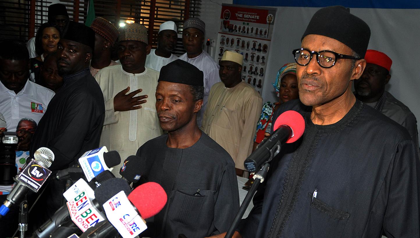 Nigerian president-elect Muhammadu Buhari (right) reads his acceptance speech in Abuja on April 1, 2015. Mr Buhari congratulated outgoing President Goodluck Jonathan for peacefully relinquishing power on Wednesday, a day after becoming the first poli