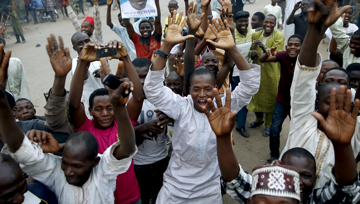 Supporters of the presidential candidate Muhammadu Buhari and his All Progressive Congress (APC) party celebrate in Kano on Tuesday. Three after Buhari became the first Nigerian to oust a president through the ballot box, putting him in charge of Afr