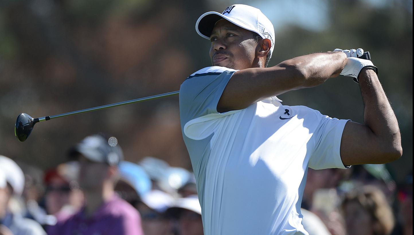 Tiger Woods plays his tee shot on the 10th hole of the north course during the first round of the Farmers Insurance Open at Torrey Pines Golf Course on Feb 5 in La Jolla, California. -- PHOTO: AFP&nbsp;