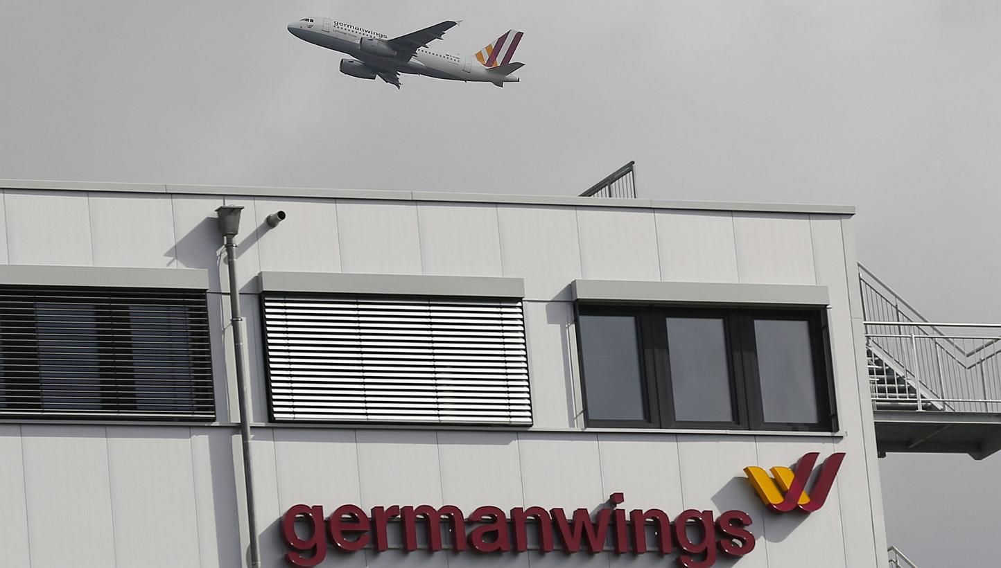 A Germanwings aircraft takes off from Cologne-Bonn airport in front of dark clouds on March 27. -- PHOTO: REUTERS
