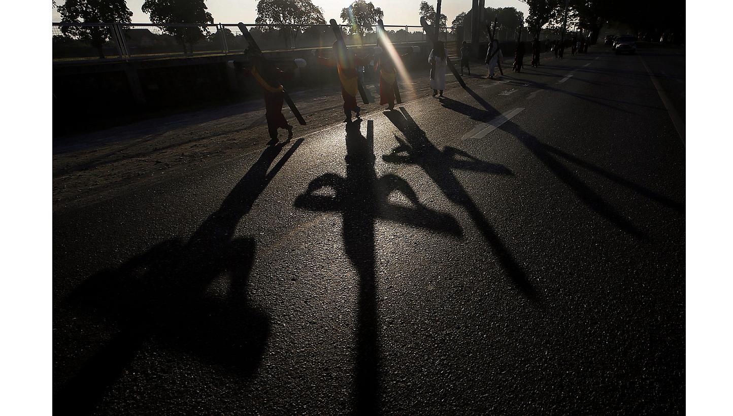 Filipino flagellants carry a wooden cross on their back along a street on Maundy in Mabalacat city, Pampanga Province, in Philippines on April 2, 2015. -- PHOTO: EPA