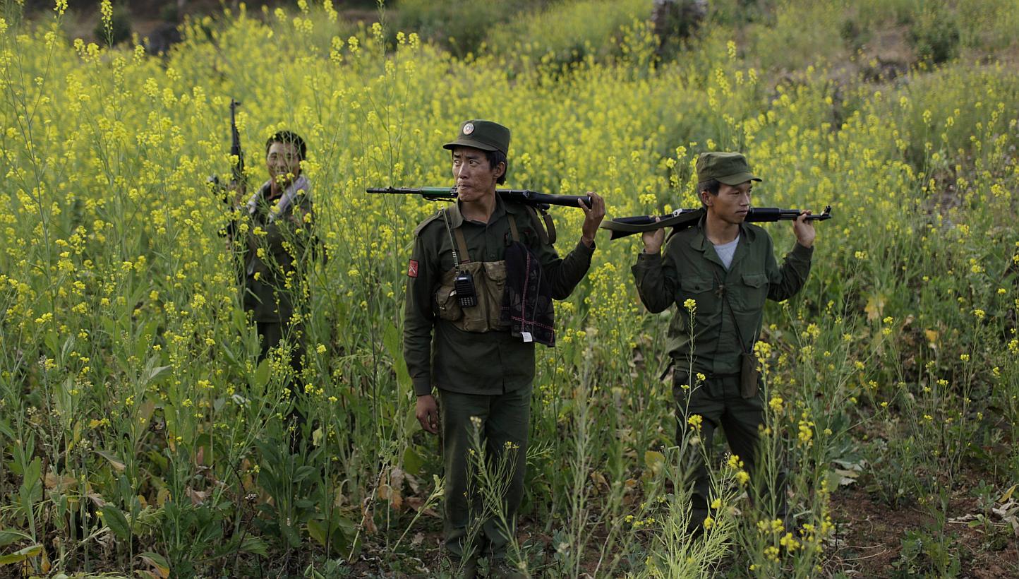 Rebel soldiers of Myanmar National Democratic Alliance Army (MNDAA) patrol near a military base in Kokang region on March 10, 2015. Myanmar has accepted responsibility and apologised for bombs dropped on Chinese territory last month during clash