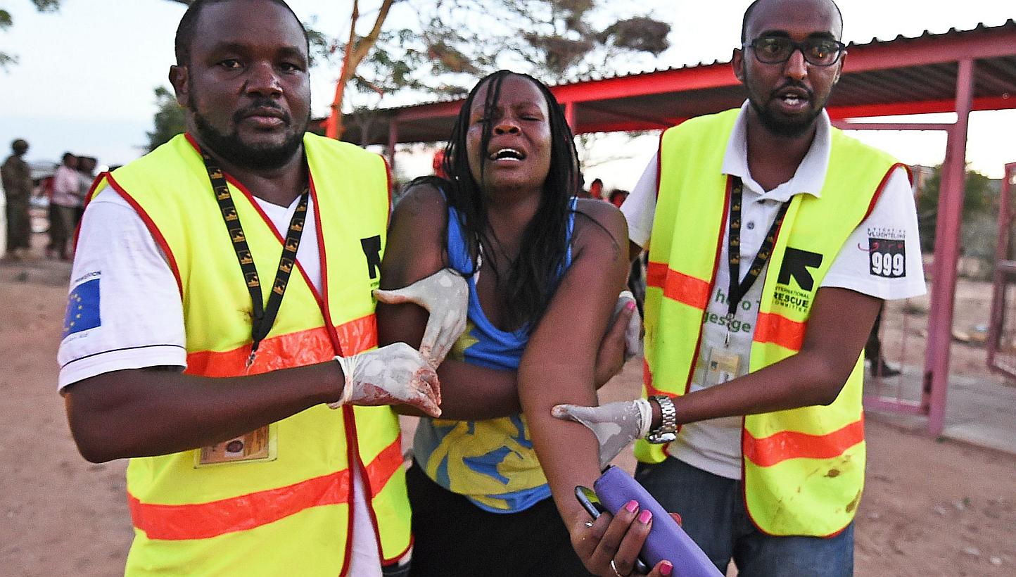 Paramedics help a student who was injured during an attack by Somalia's Al-Qaeda-linked Shebab gunmen on the Moi University campus in Garissa on April 2, 2015.&nbsp;Somali Al-Shabaab militants said they were still holding many hostages inside a Kenya