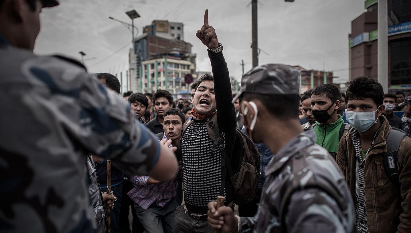 Riot police officers maintaining law and order on a street in Kathmandu yesterday as earthquake survivors desperate to leave the Nepalese capital showed their anger after promised special bus services failed to materialise.