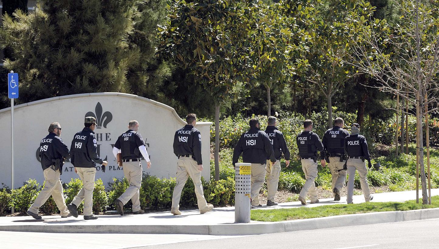 Federal agents walking past a location of a suspected "baby tourism" operation, in Irvine, California on March 3, 2015. -- PHOTO: REUTERS