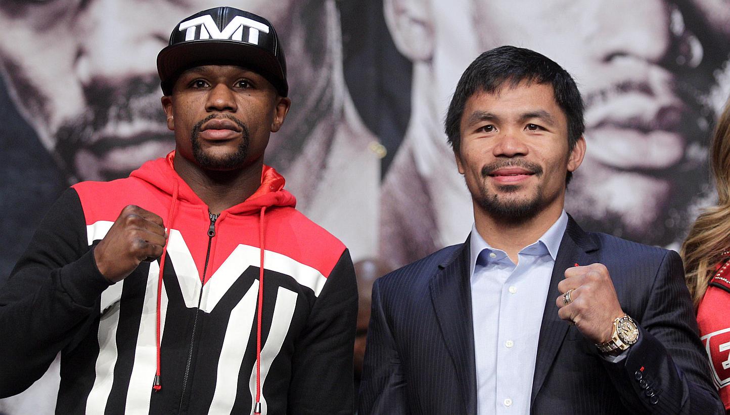 WBC/WBA welterweight champion Floyd Mayweather (left) and WBO welterweight champion Manny Pacquiao pose during a news conference at the KA Theatre at MGM Grand Hotel & Casino on April 29, 2015, in Las Vegas, Nevada. -- PHOTO: AFP 