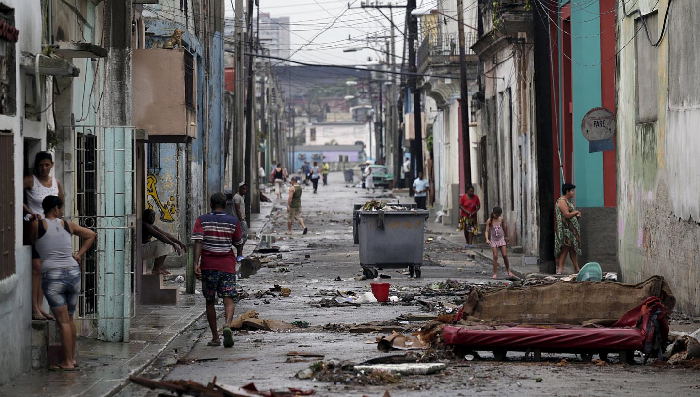 People walk on a street after flooding caused by heavy rains in Havana April 30, 2015.&nbsp;Three people died as a result of torrential rains and high winds that damaged more than two dozen structures and flooded parts of Havana, local media reported