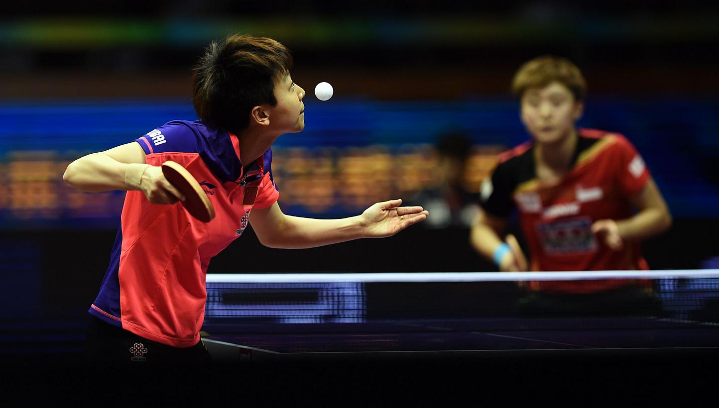 Mu Zi of China serving against Feng Tianwei of Singapore at the World Table Tennis Championships at the Suzhou International Expo Centre in Suzhou on May 1, 2015. -- PHOTO: AFP&nbsp;