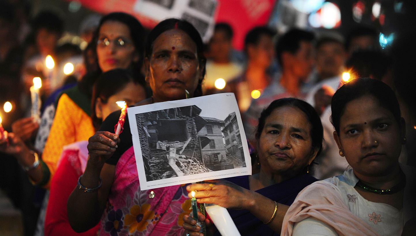 Nepalese participating in a candlelight vigil to pray for the April 25, 2015, earthquake victims, in Allahabad on May 1, 2015. -- PHOTO: AFP